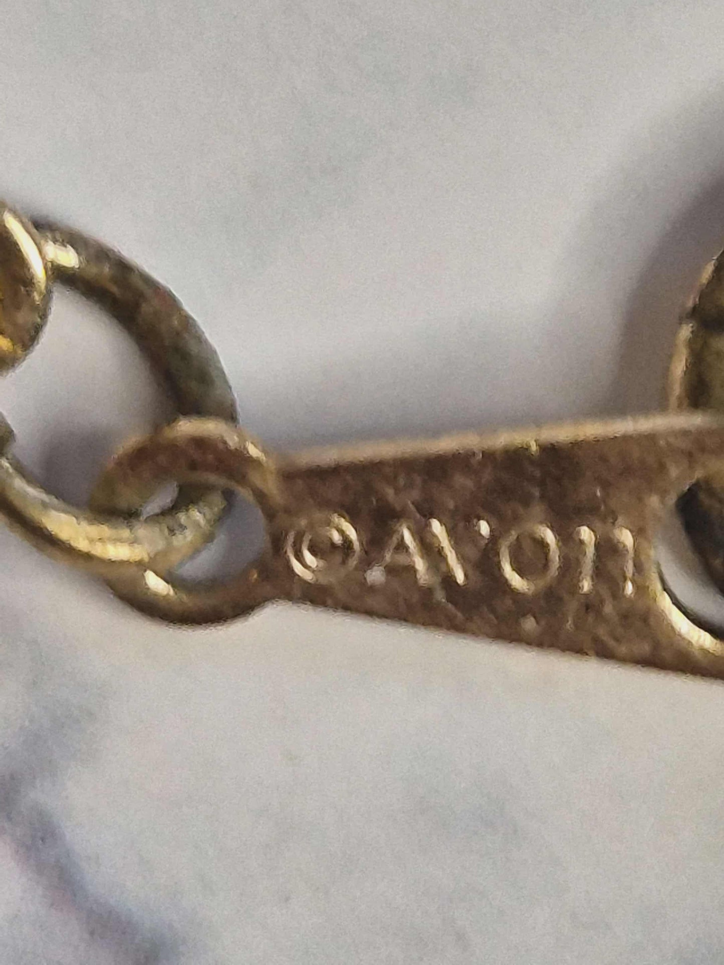 Avon balti karoliai su auksinėmis detalėmis